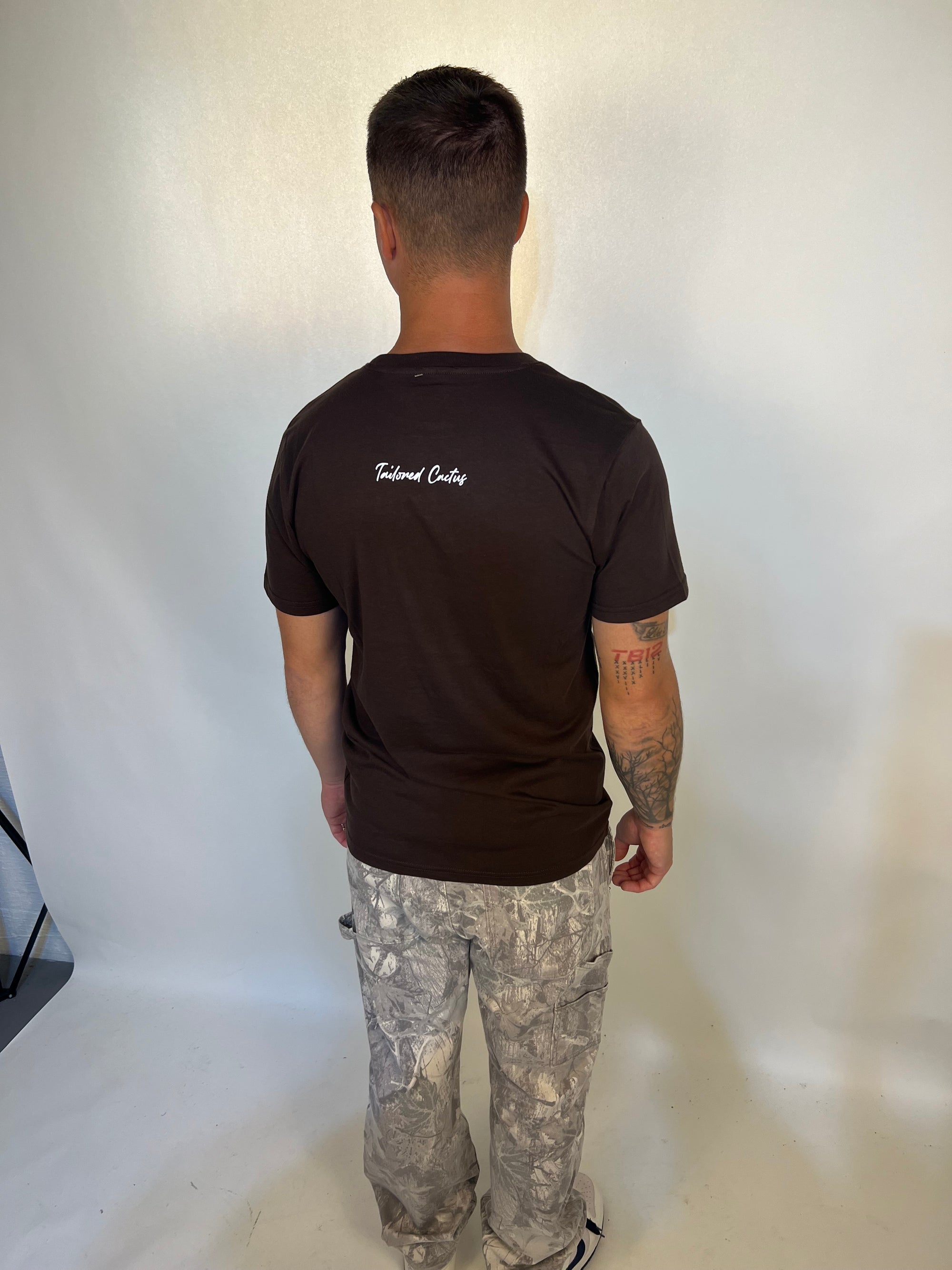 Man wearing brown tailored cactus made for more tee shirt 