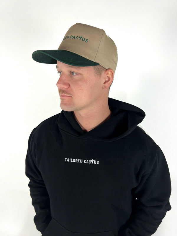 Guy wearing tailored cactus trucker hat and black hoodie with tailored cactus on front 