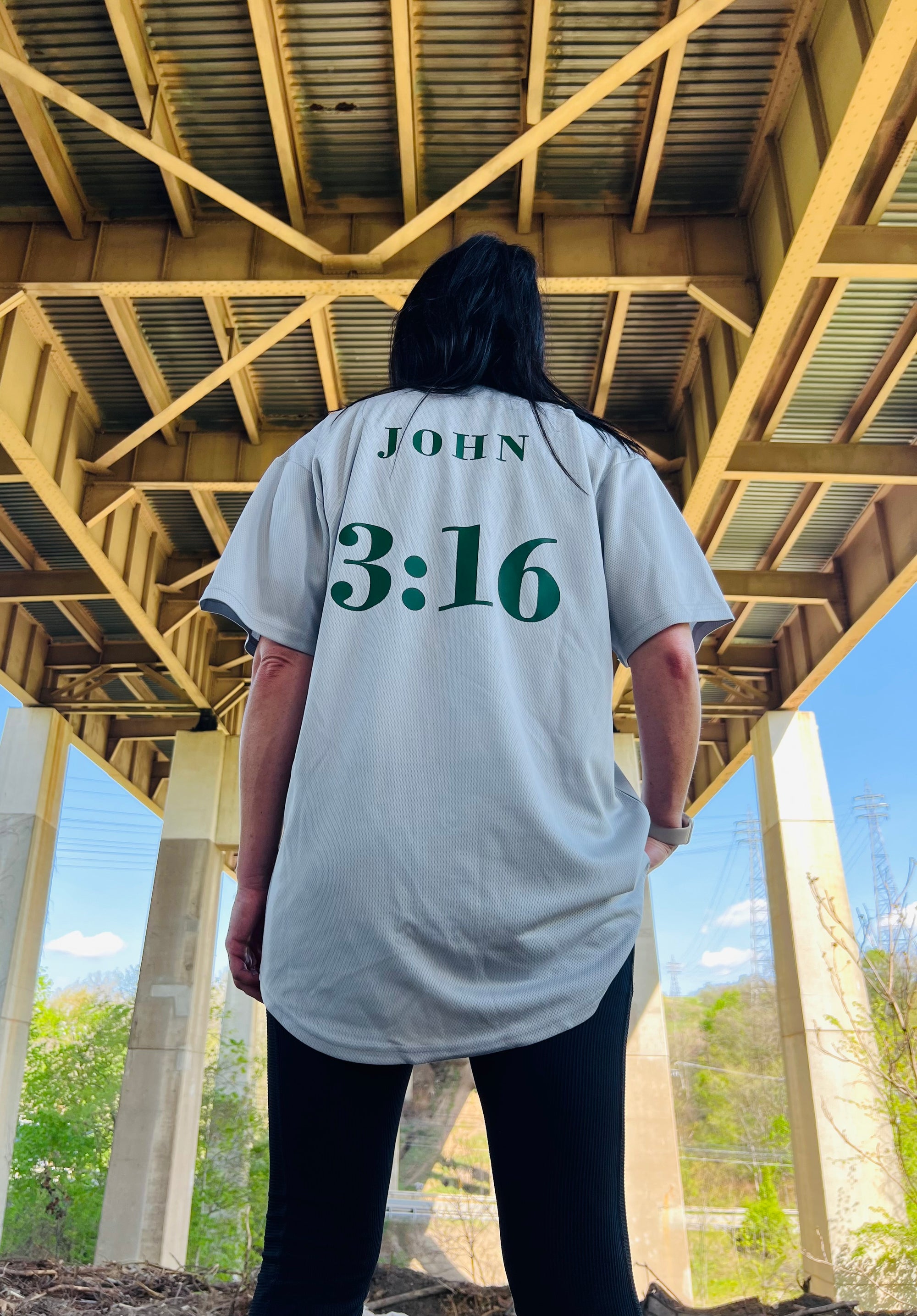 Back of woman in tailored cactus baseball jersey with John 3:16 on back 