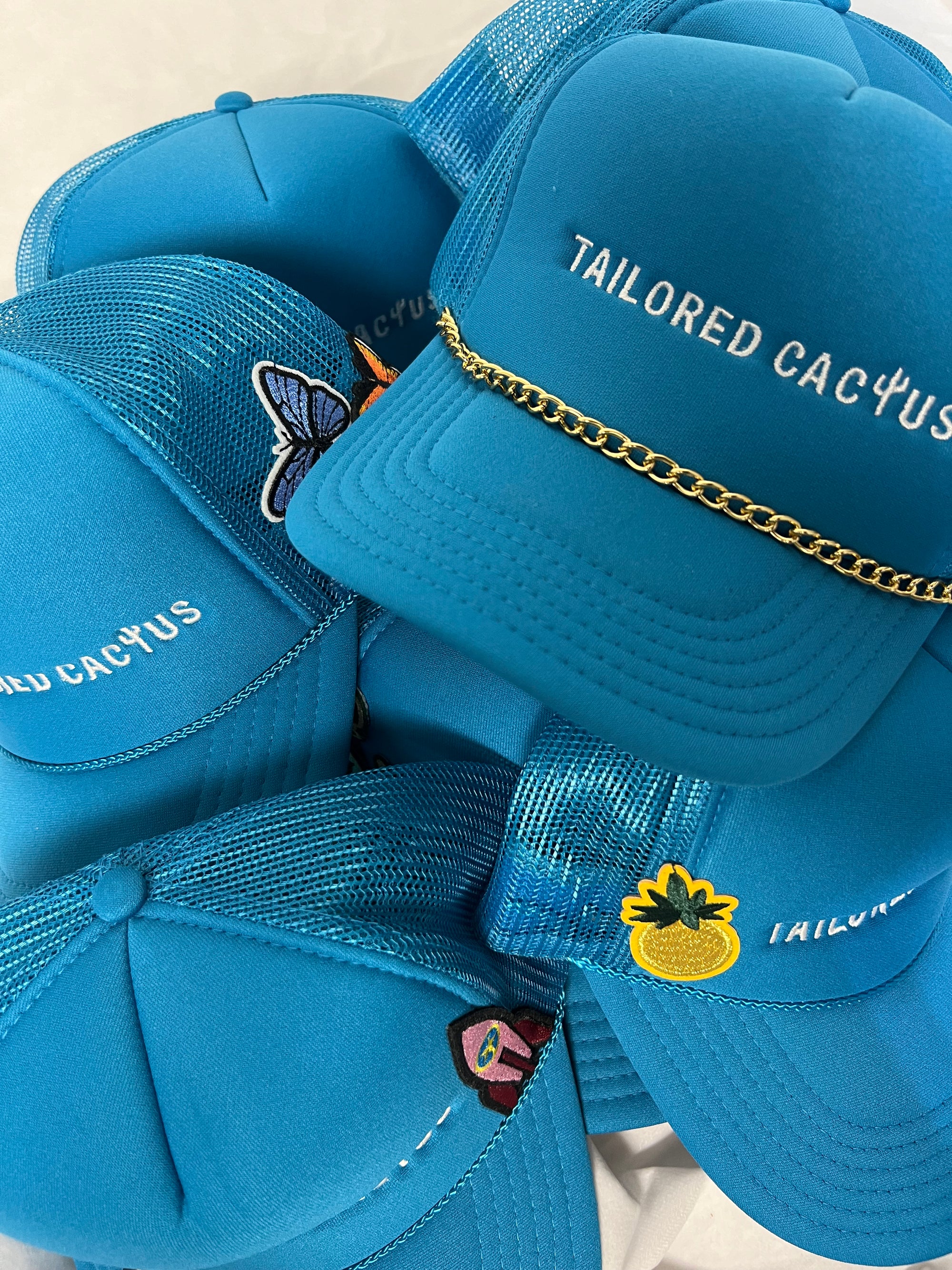 Tailored cactus trucker hats with patches and charms 