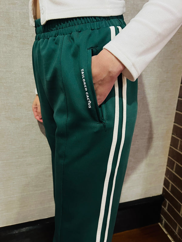 Tailored cactus girl in green pants with white bow