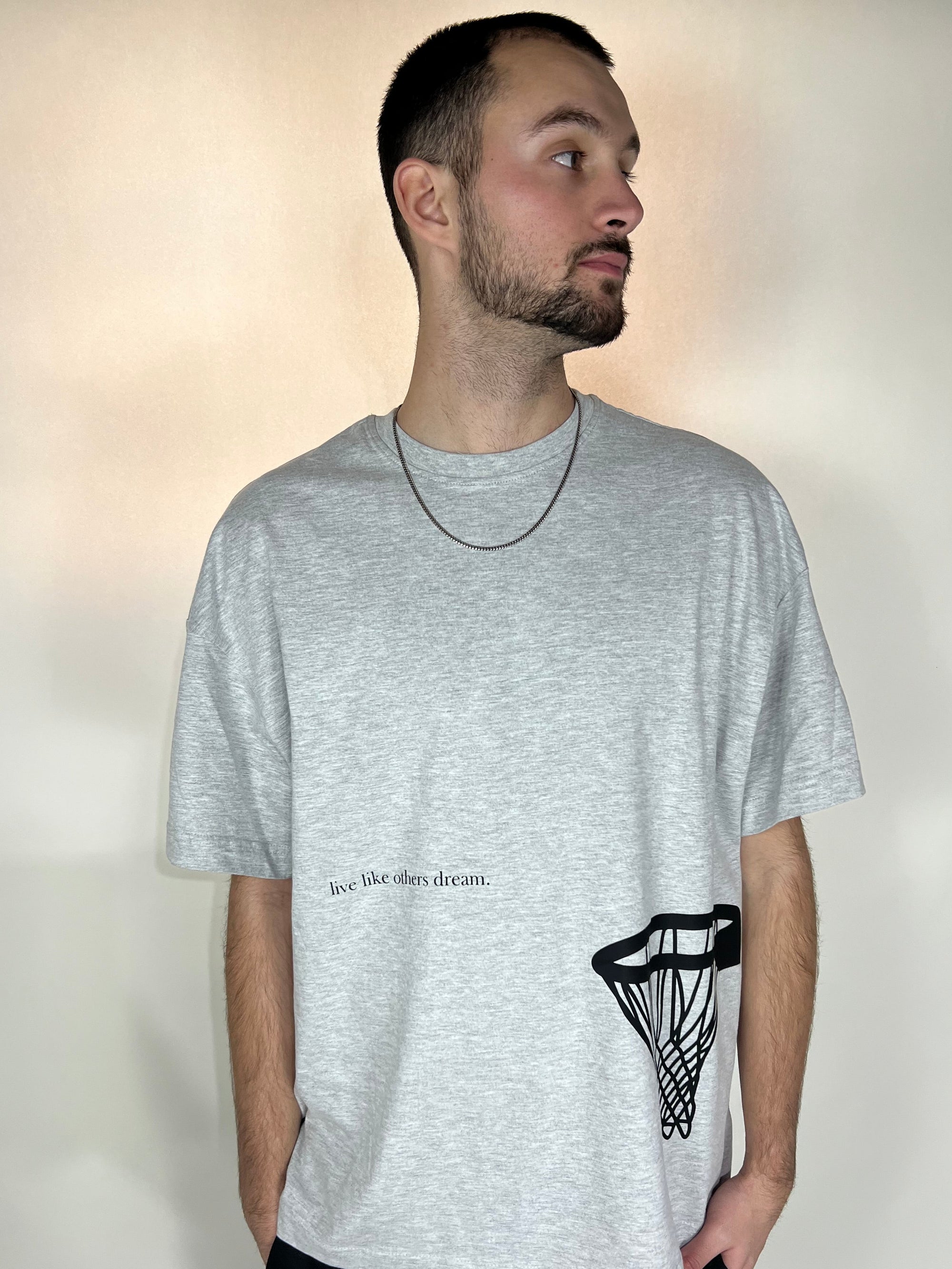 Tailored cactus man in grey tee shirt with live like other dream and basketball hoop 