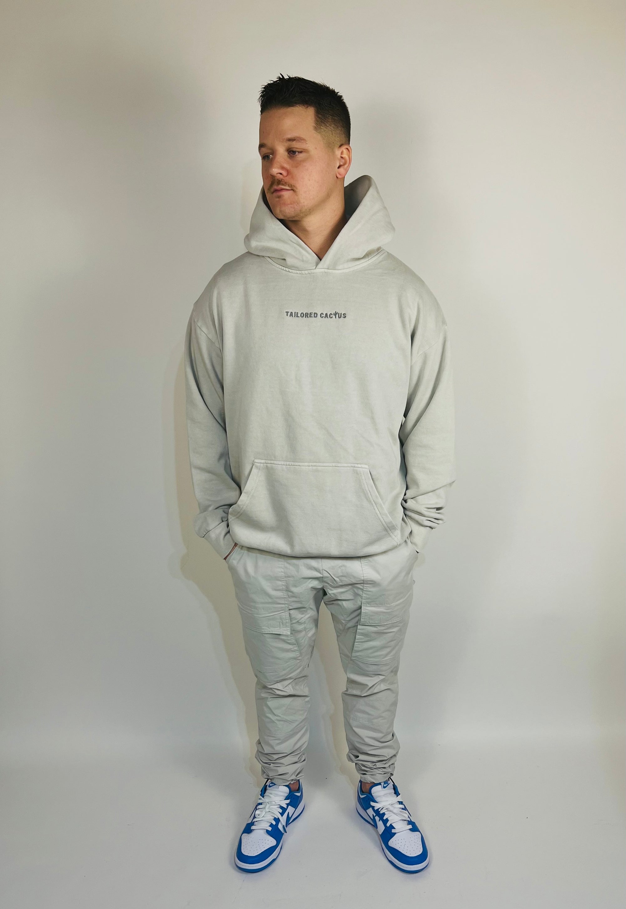 Man wearing marble hoodie with tailored cactus on front 