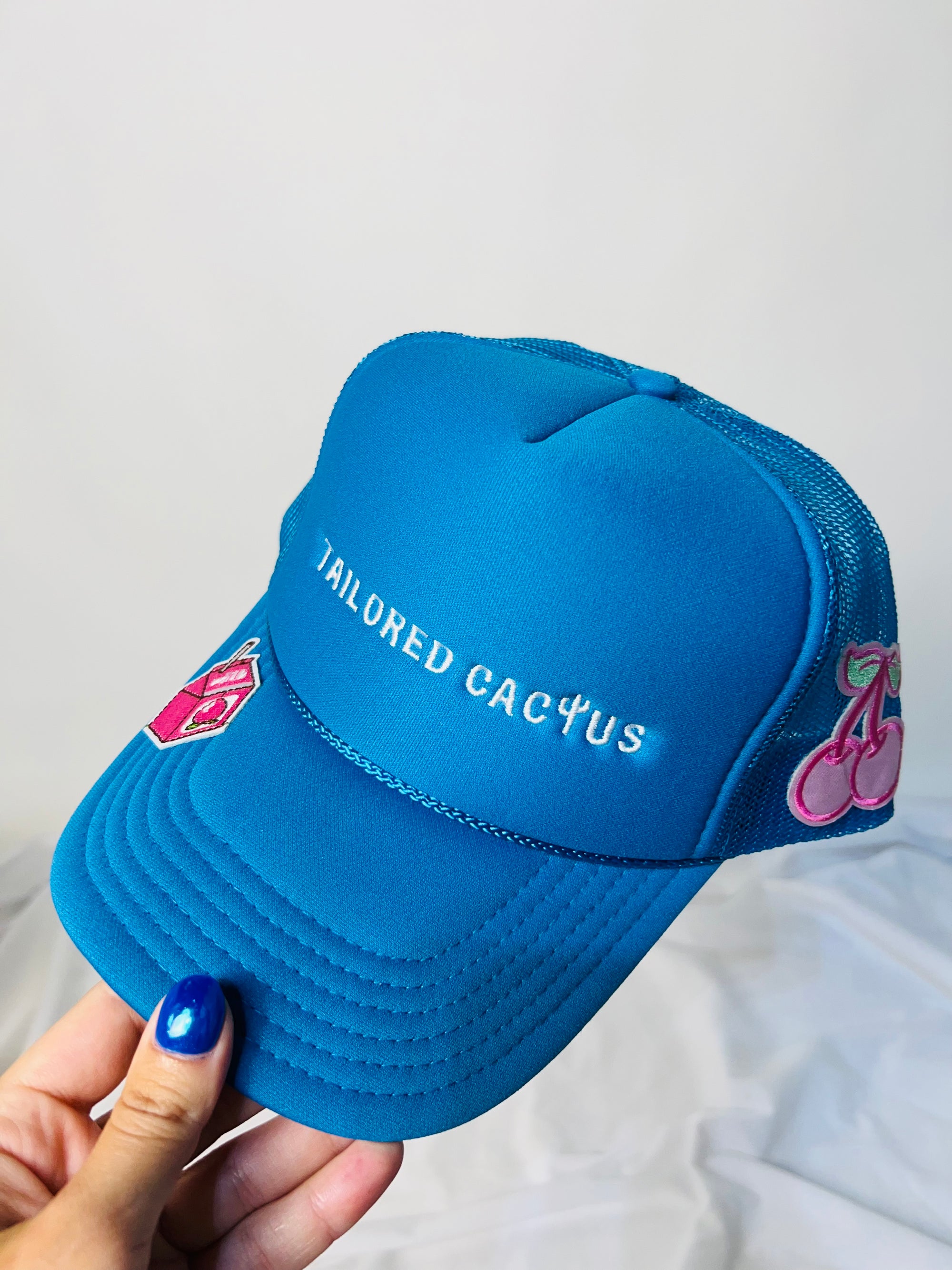 Tailored stubble trucker hat with link cherries and milk carton 