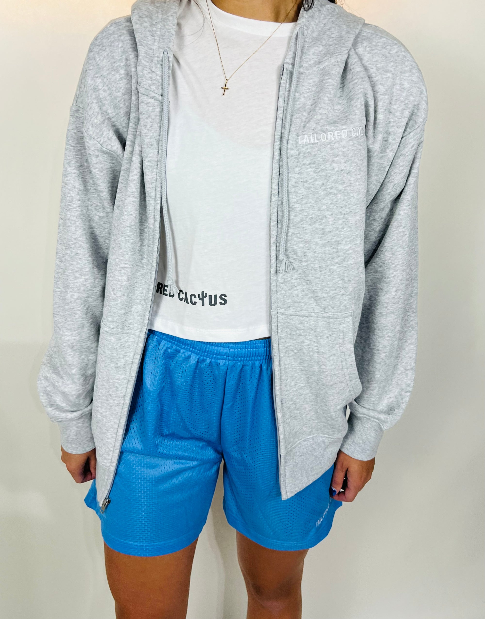 Tailored cactus girl in grey zip up and blue shorts 