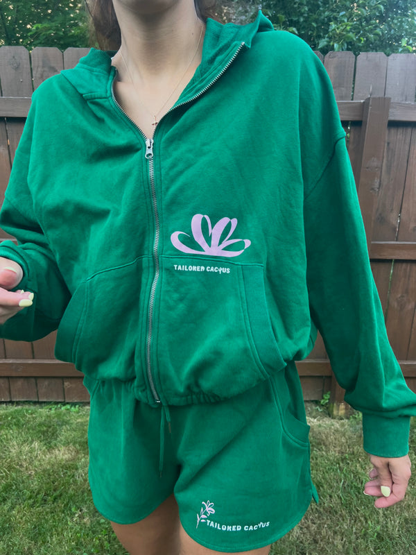 Girl in tailored cactus green matching sweat shorts and jacket with pink flowers 
