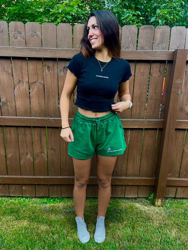 Tailored cactus girl in green shorts and black baby tee with lettuce edges