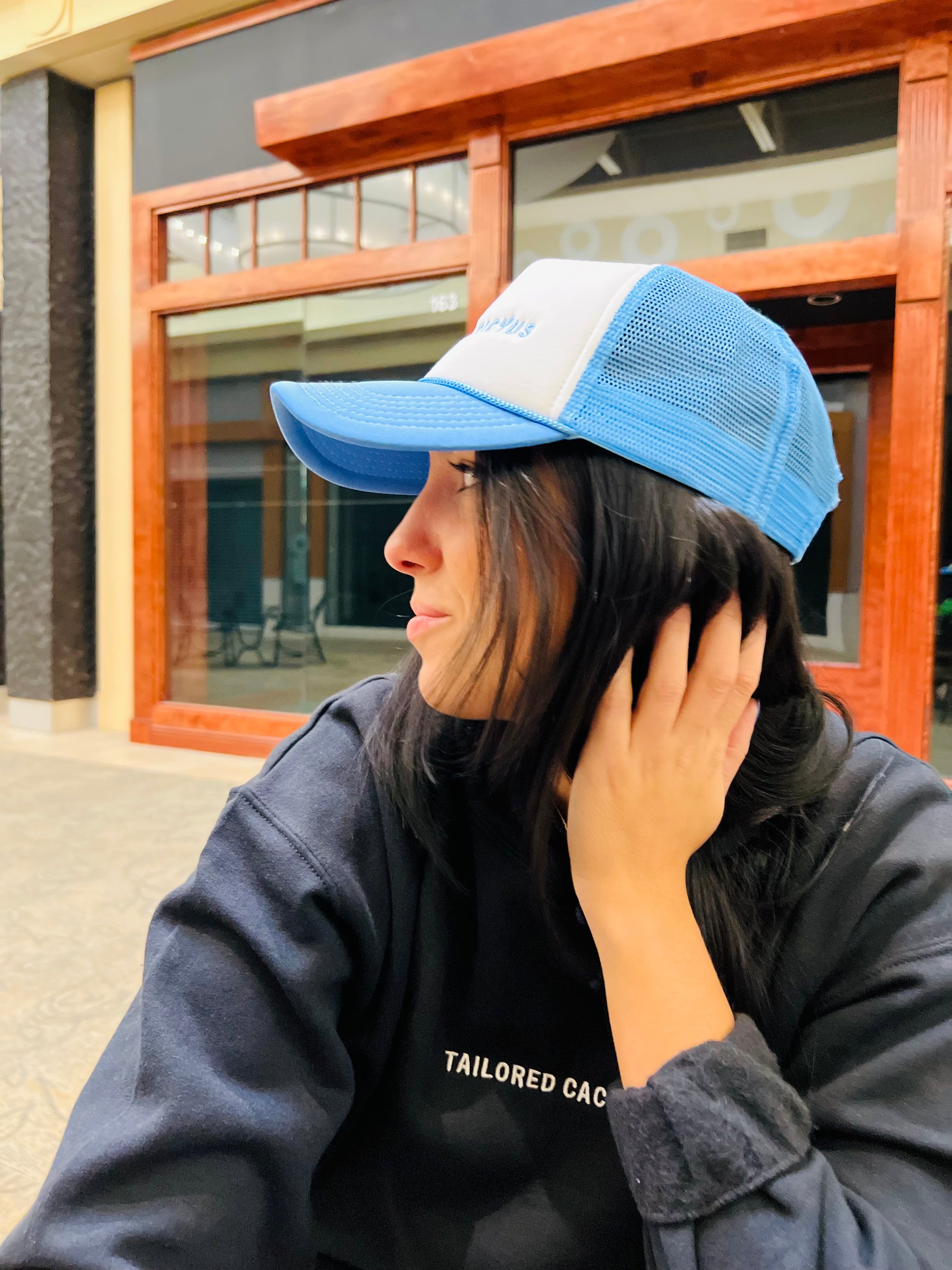 Girl in tailored cactus blue and white trucker hat 