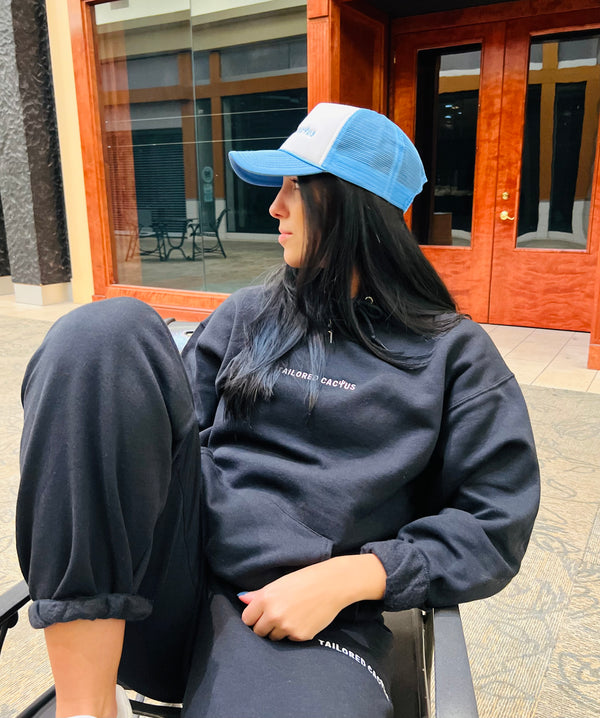 Girl in tailored cactus blue and white trucker hat 