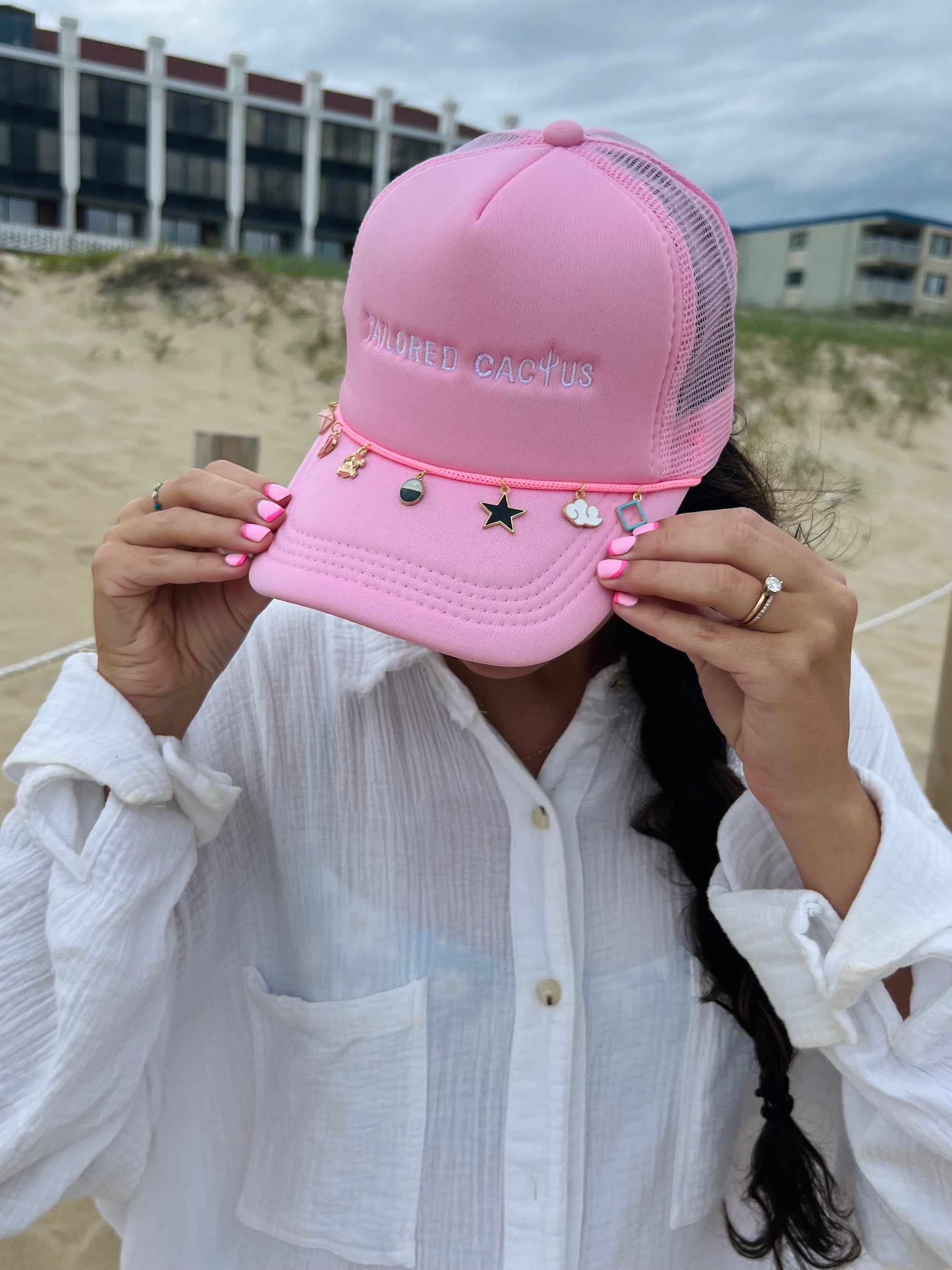 Girl in pink tailored cactus trucker hat with charms 