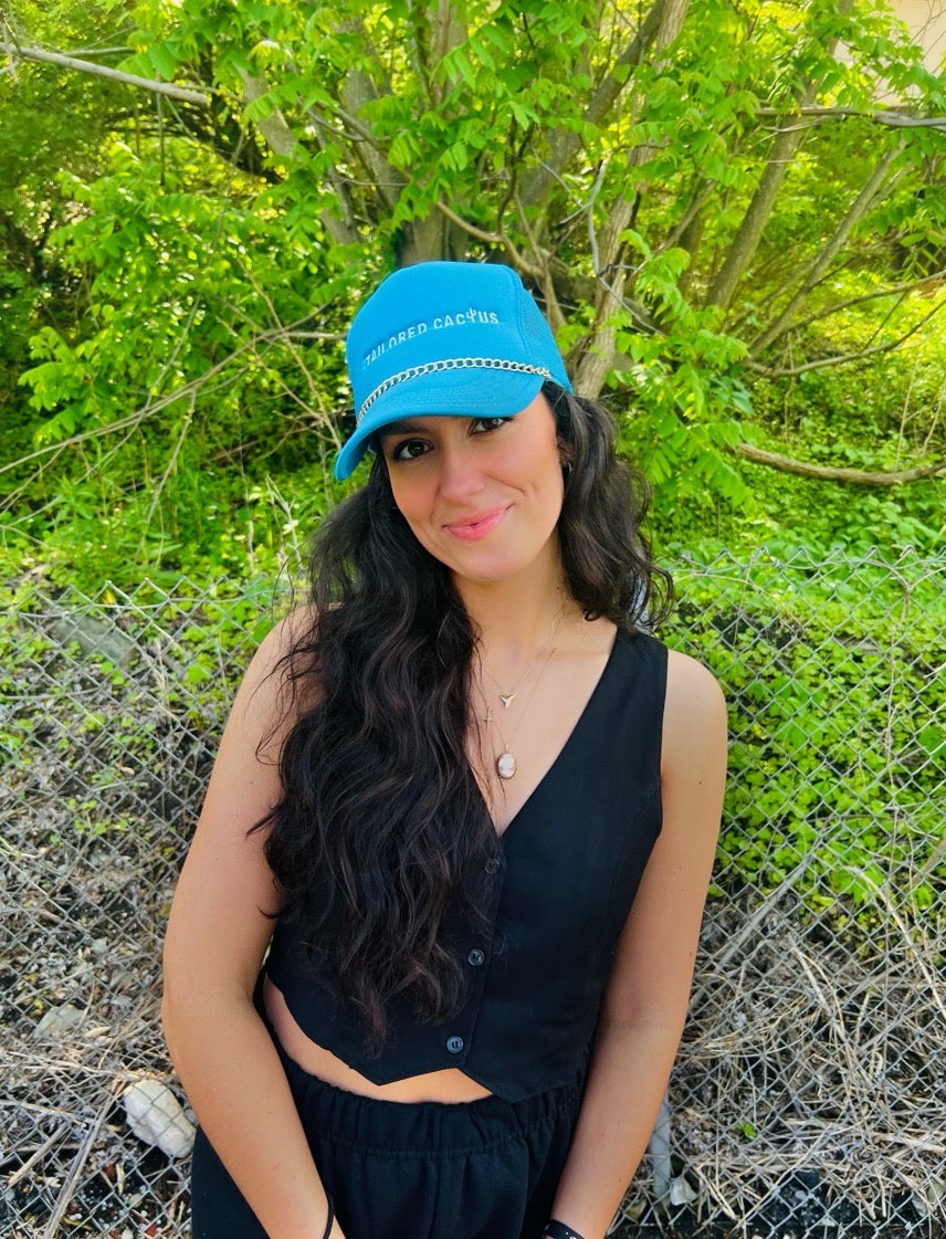 Tailored cactus girl in blue trucker hat with gold chain 