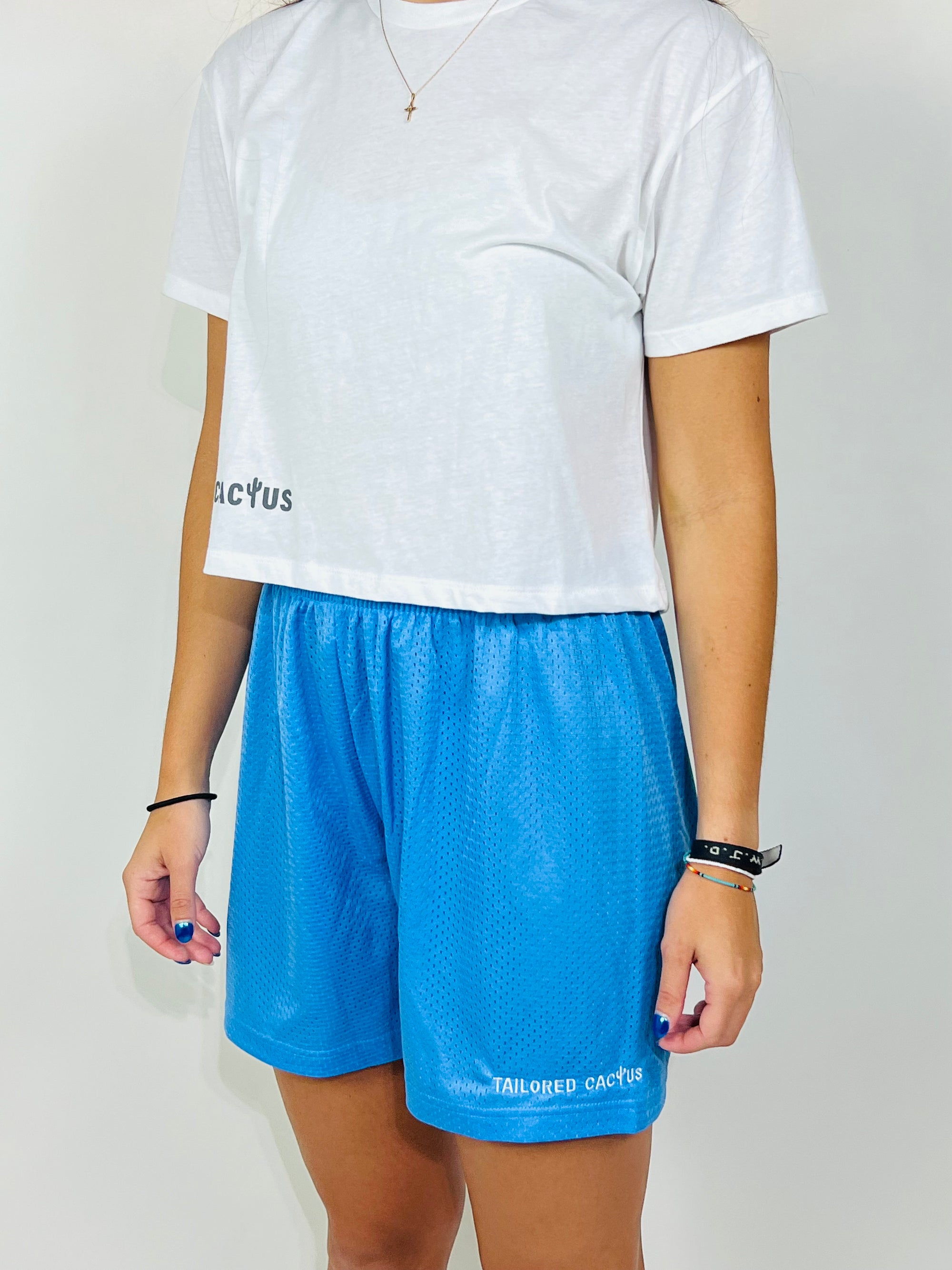 Tailored cactus girl in blue mesh shorts and white cropped tee 