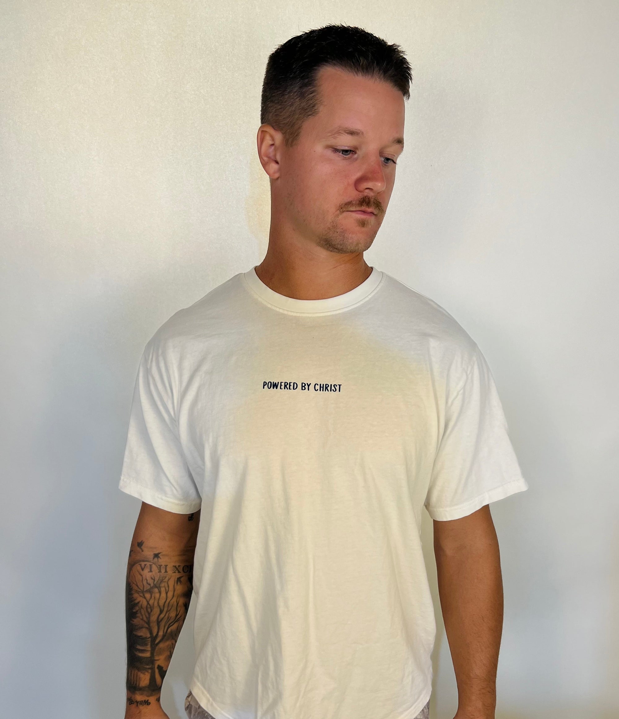 Man in tailored cactus powered by faith white t shirt 