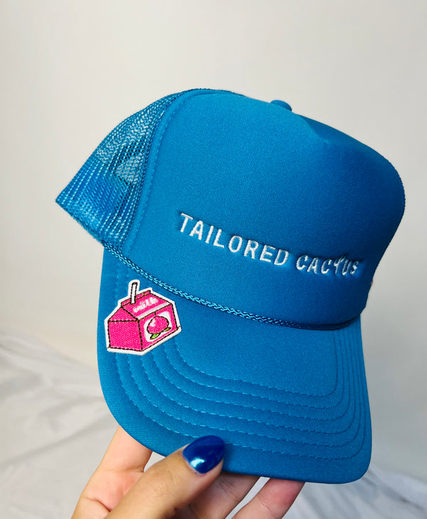 Blue tailored cactus trucker hat with strawberry milk carton 