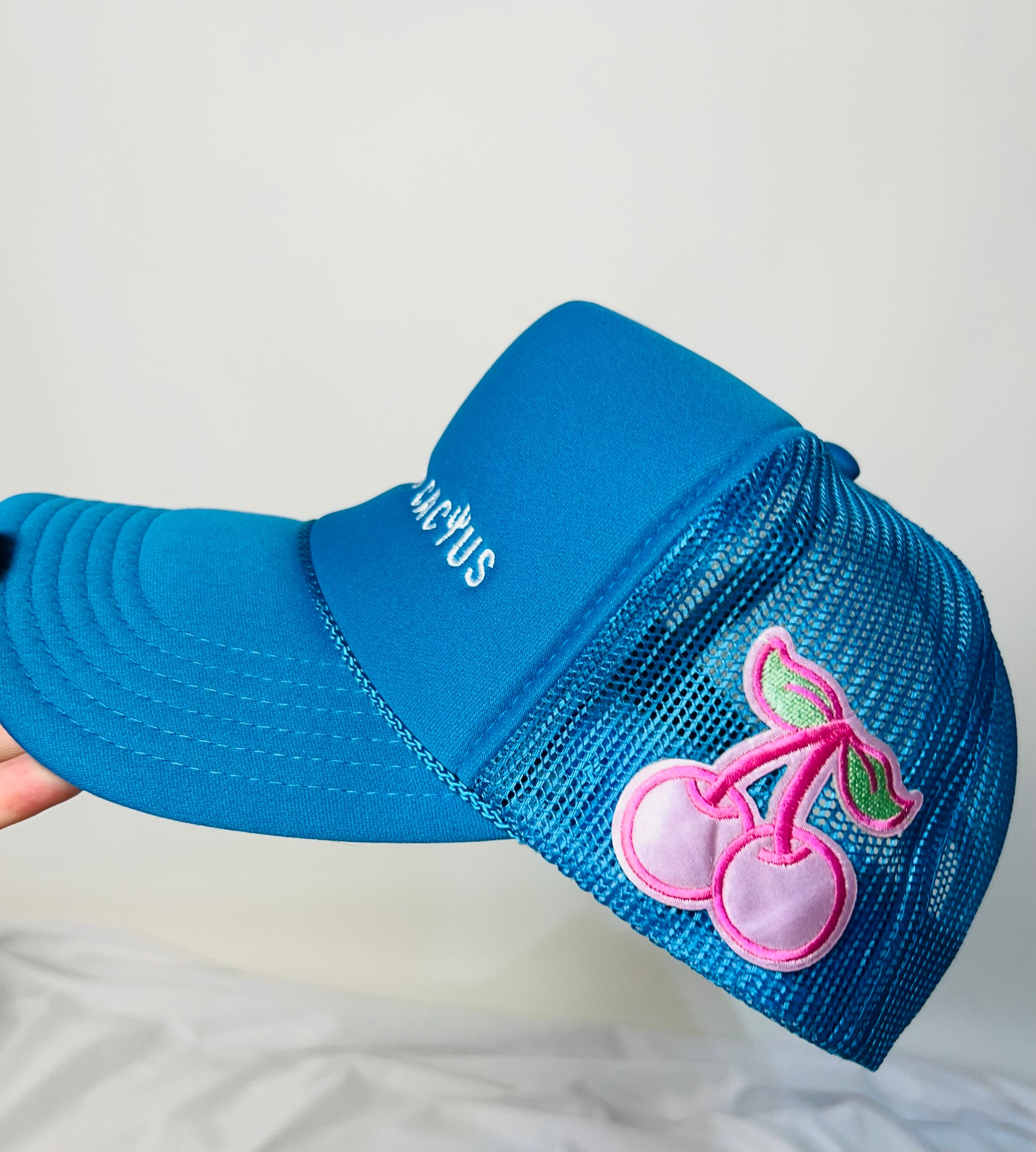 Tailored cactus blue trucker hat with pink cherries 