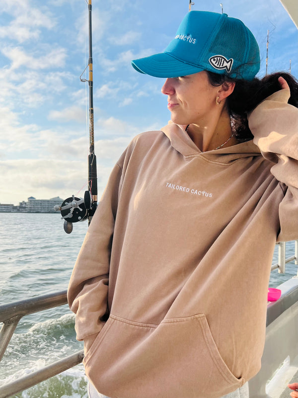 Girl fishing in tailored cactus hoodie and hat