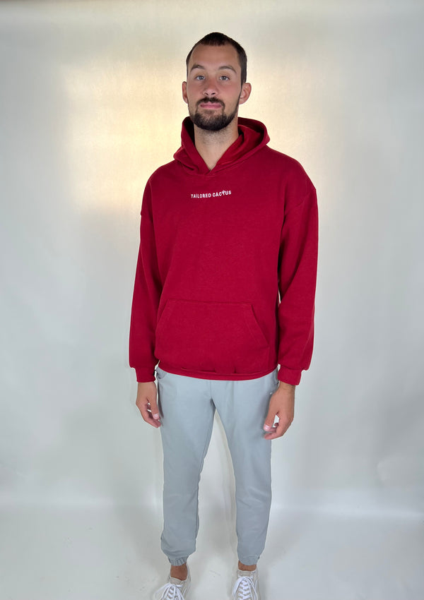 Man in tailored cactus red hoodie 