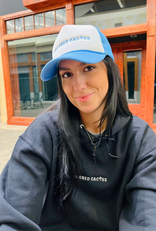 Girl in tailored cactus blue and white trucker hat 
