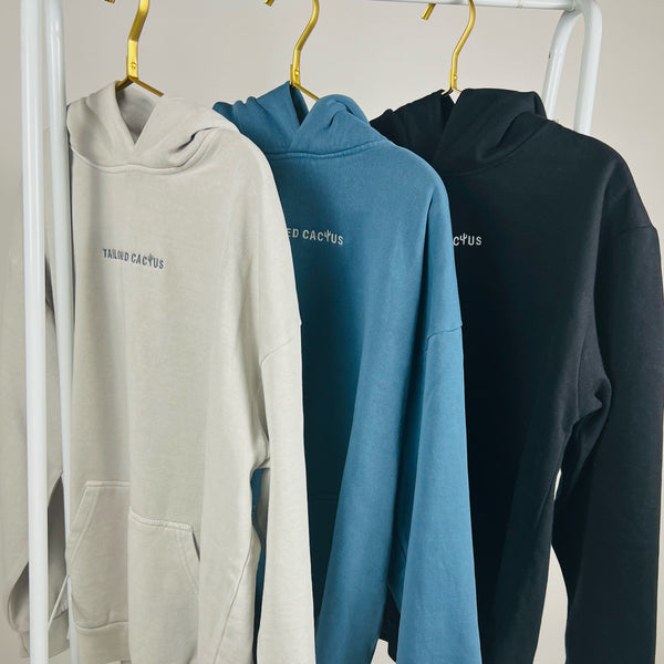 Row of tailored cactus hoodies on white, blue, and black 