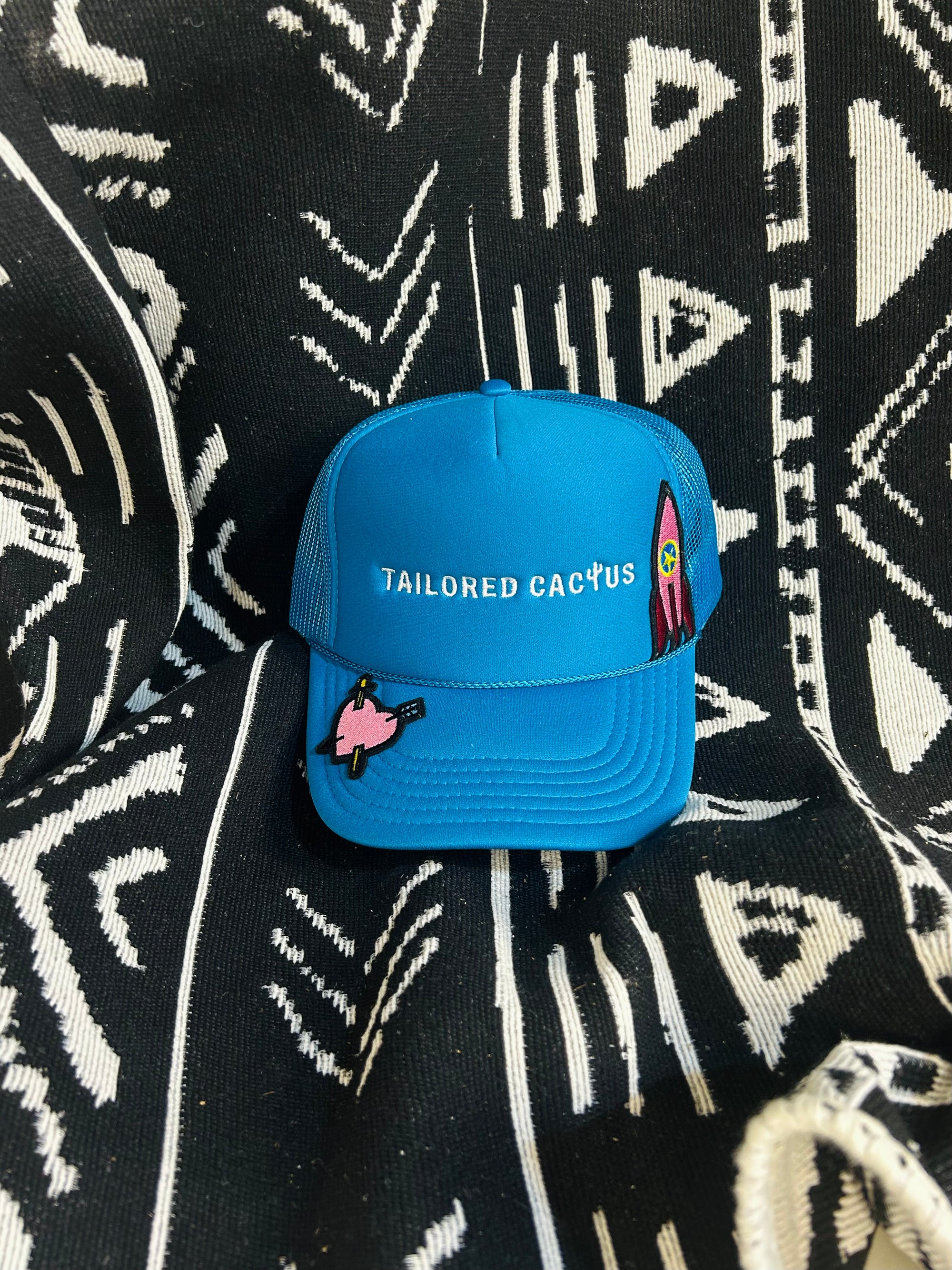 Pink patches on tailored cactus trucker hat in blue 