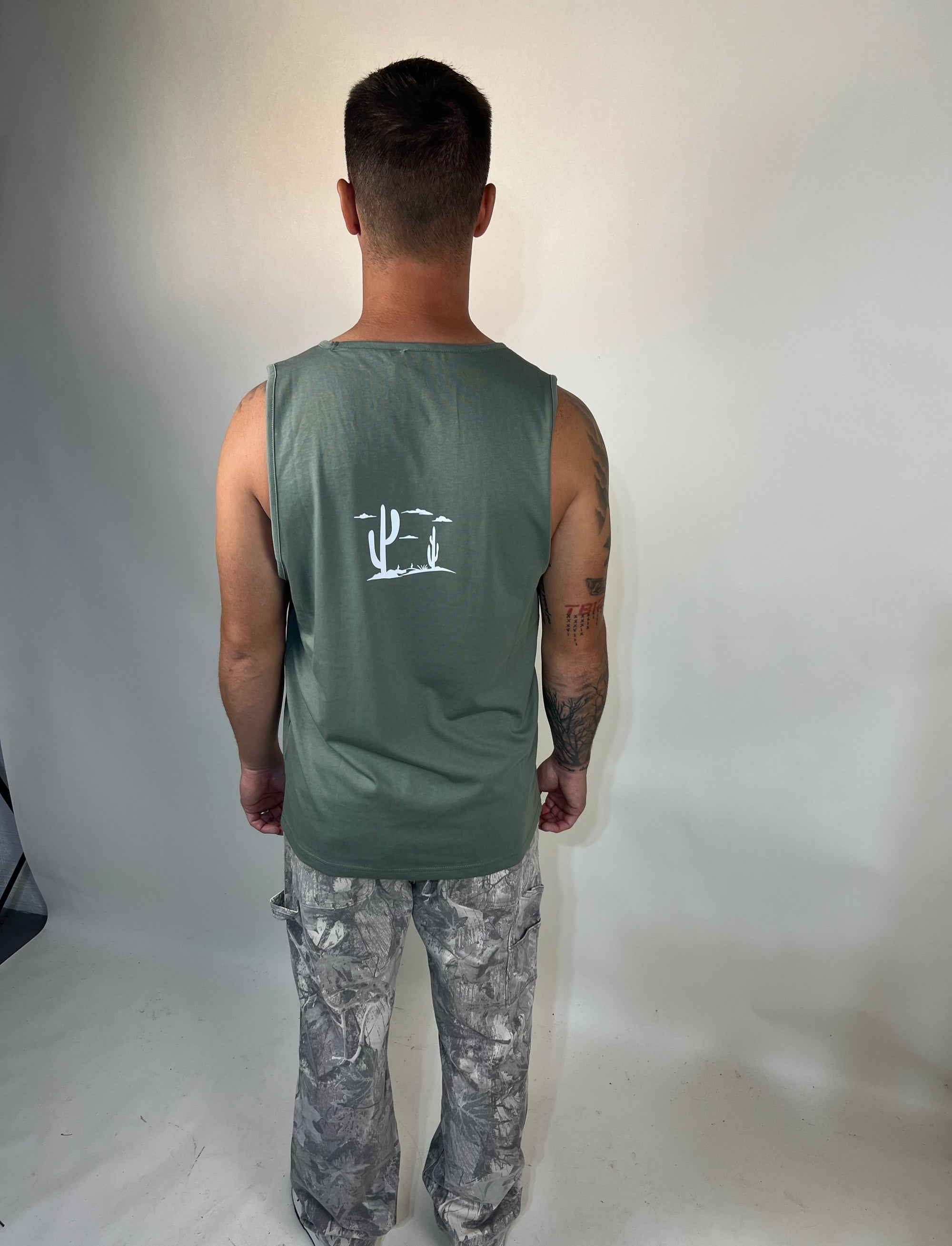 Man in tailored cactus green tank top 