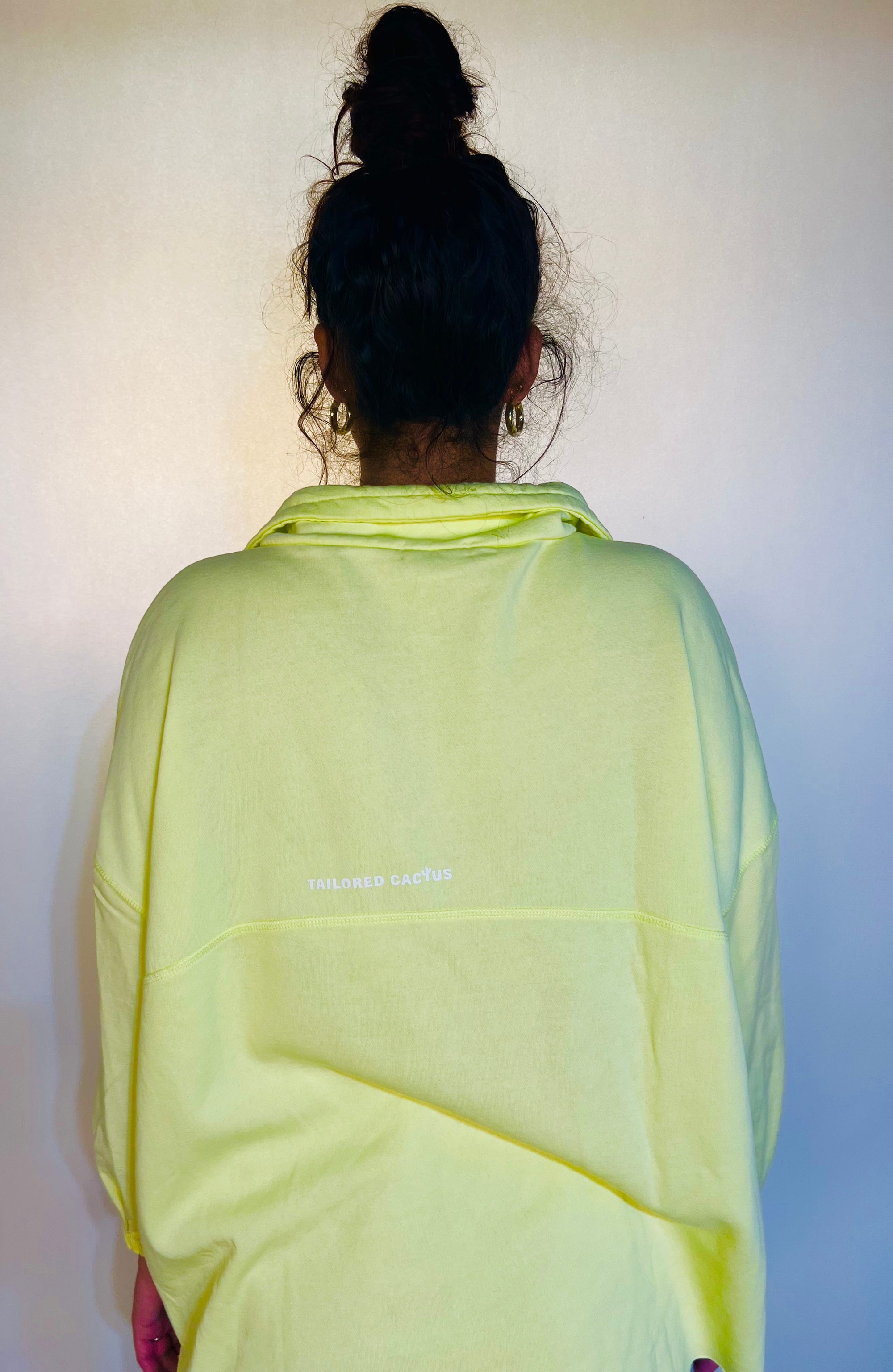 Person wearing a light green scarf with a plain background
