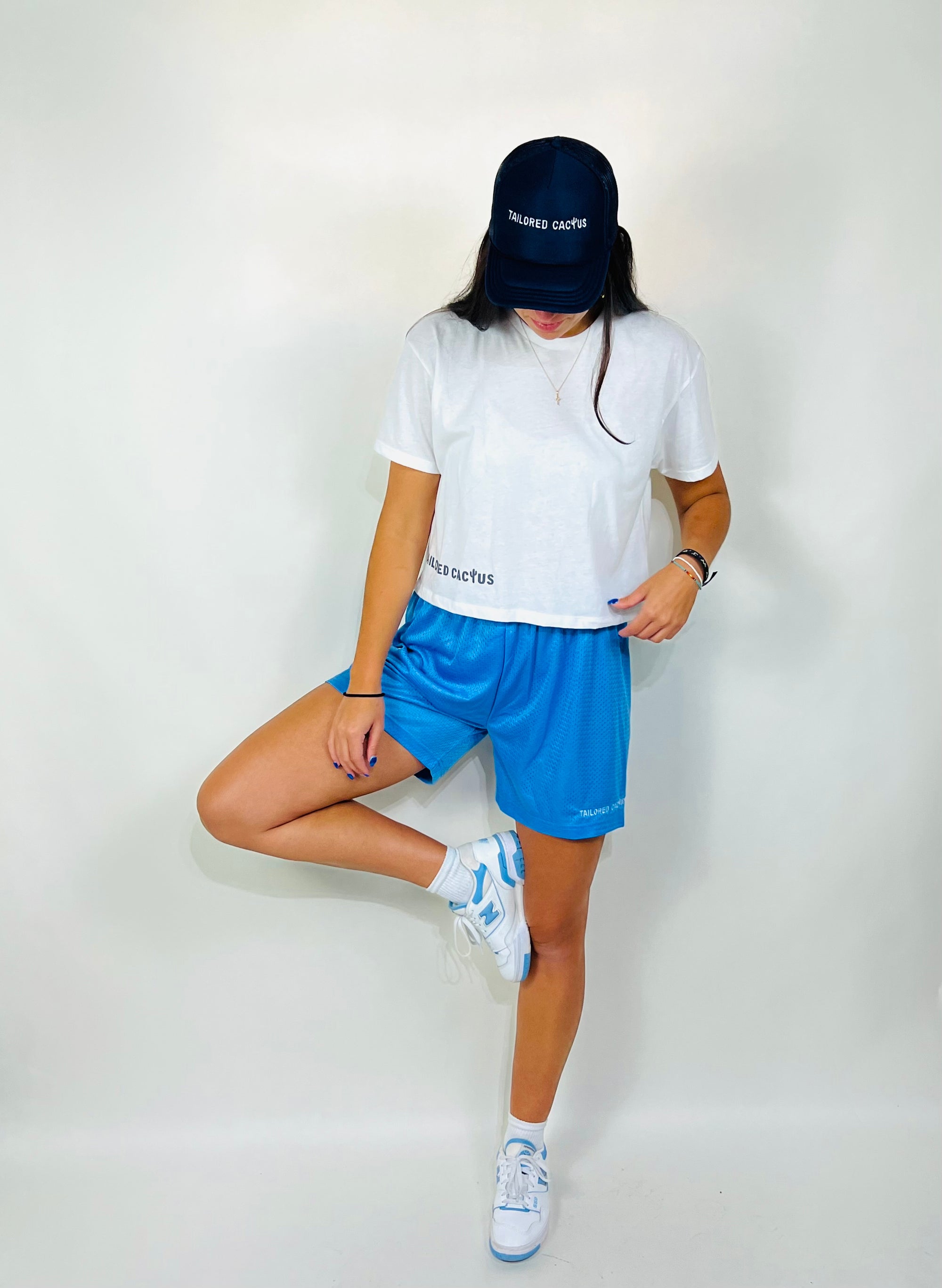 Tailored cactus girl in blue mesh shorts and white cropped tee 