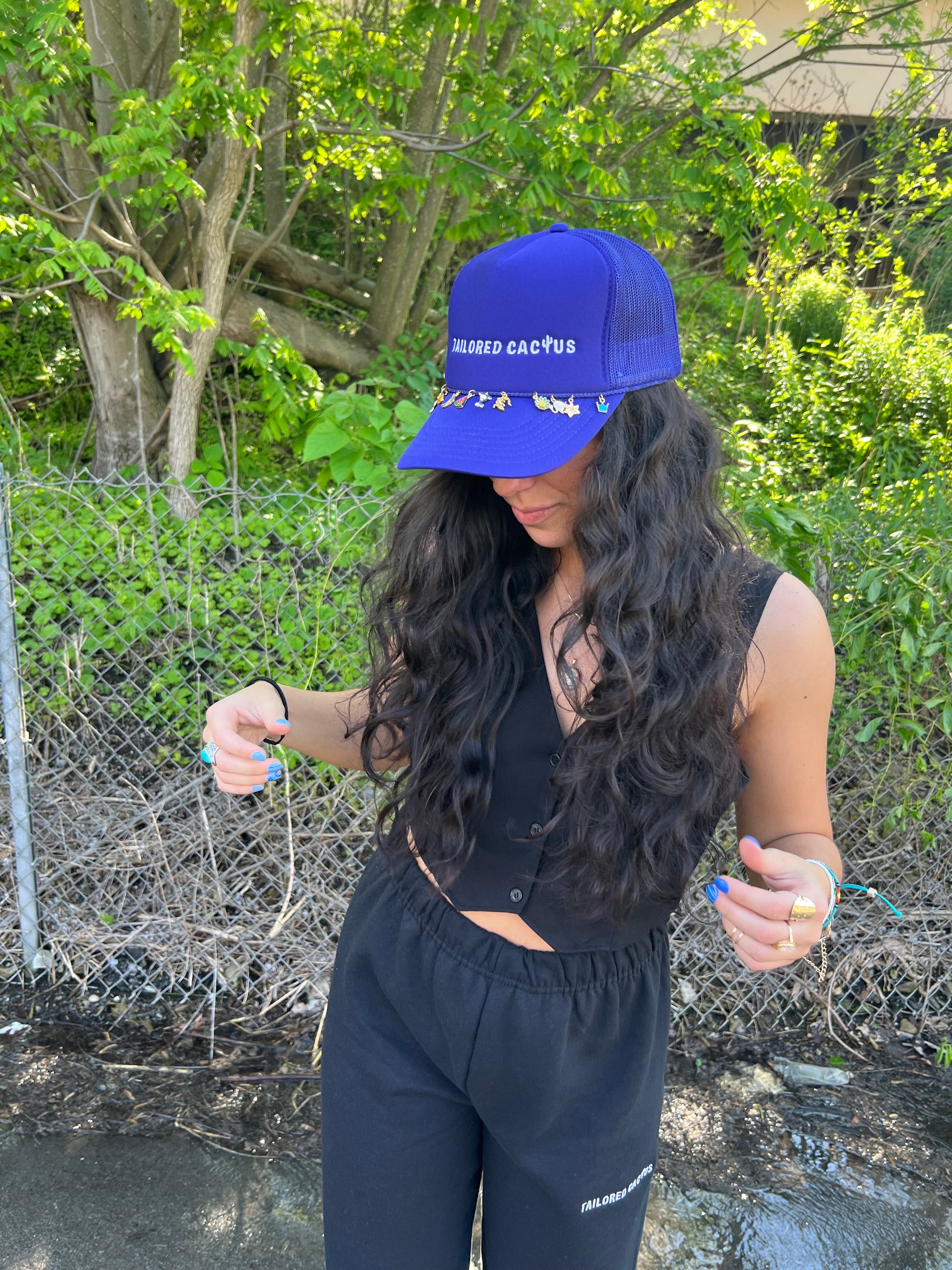 Tailored cactus girl in purple trucker hat with charms 