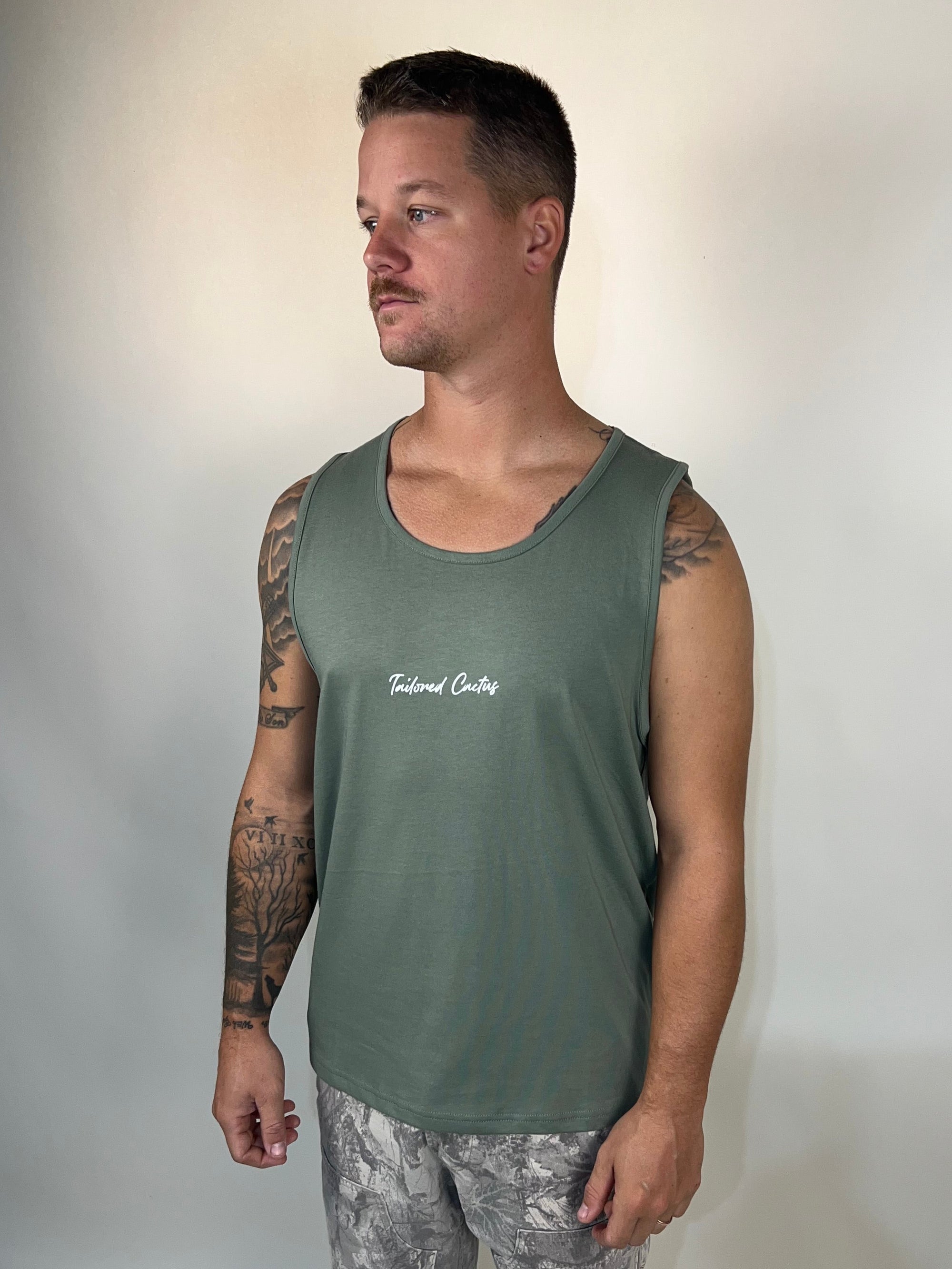 Man in tailored cactus green tank top