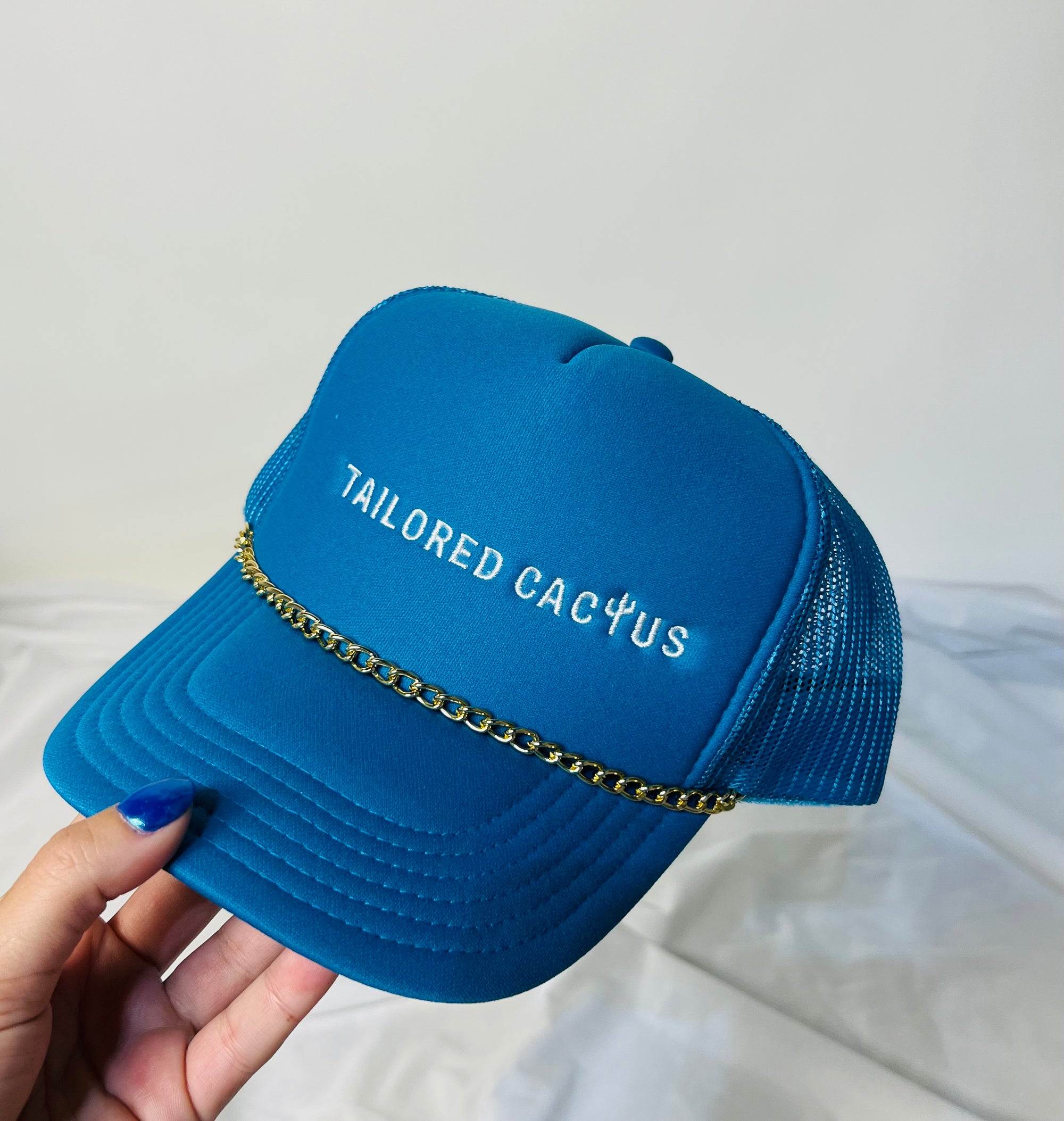 Blue tailored cactus trucker hat with gold charm 