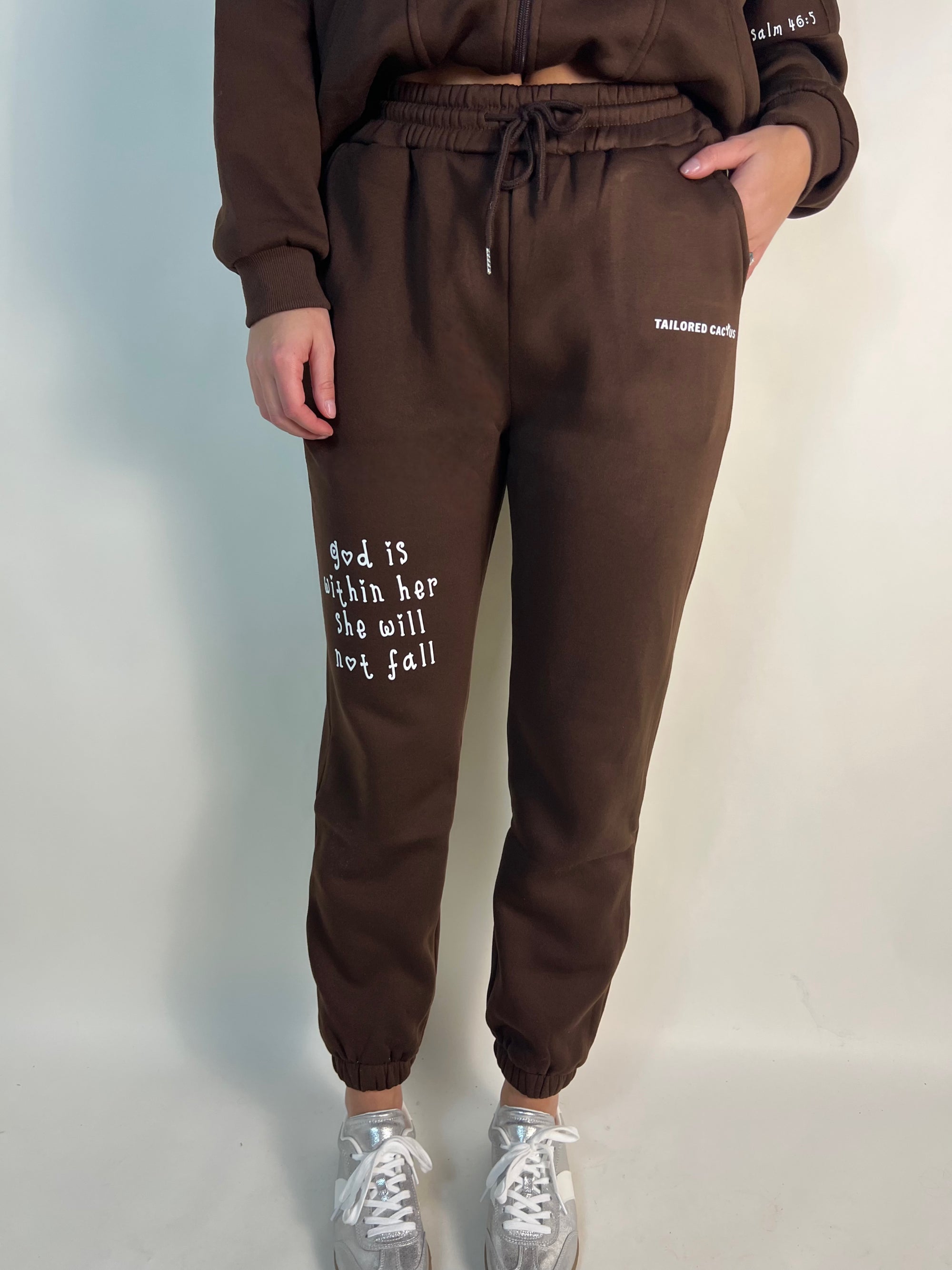 Girl in tailored cactus brown God is within her sweatpants 