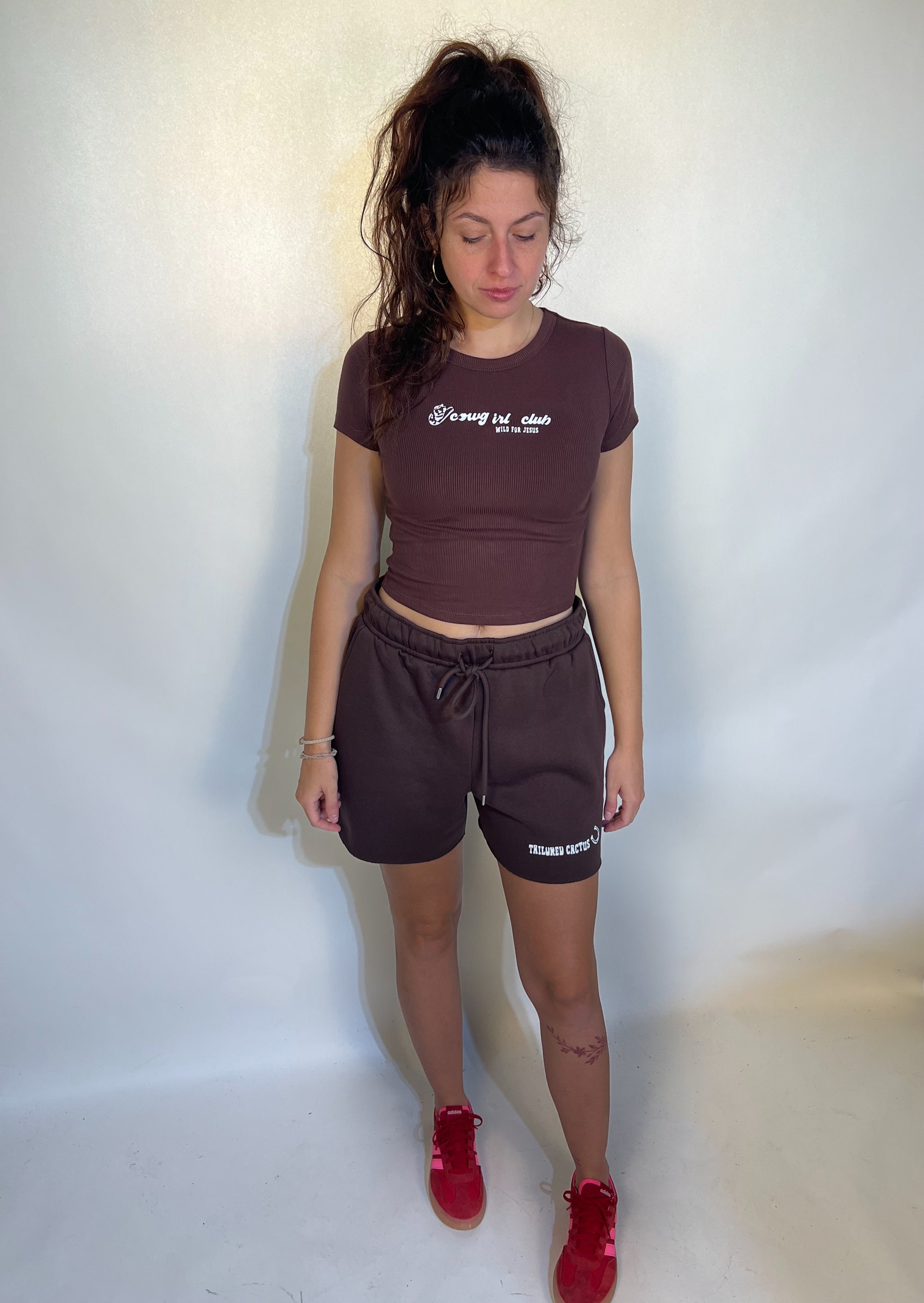 Girl on brown tailored cactus ‘cowgirls club sold for Jesus’ t shirt and brown shorts 