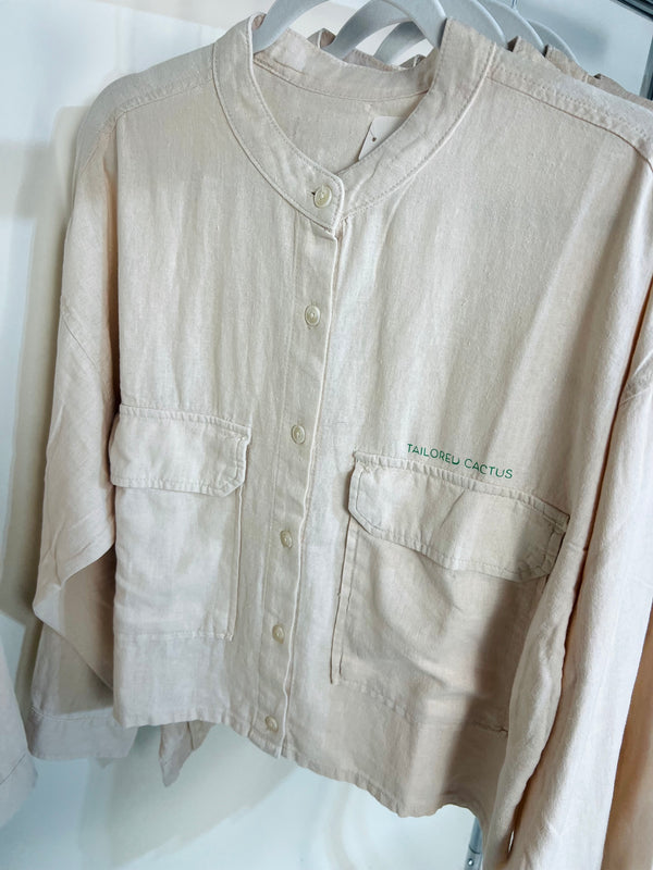 Women’s button up tailored cactus shirt with ‘WE LOVE BECAUSE HE LOVED FIRST’