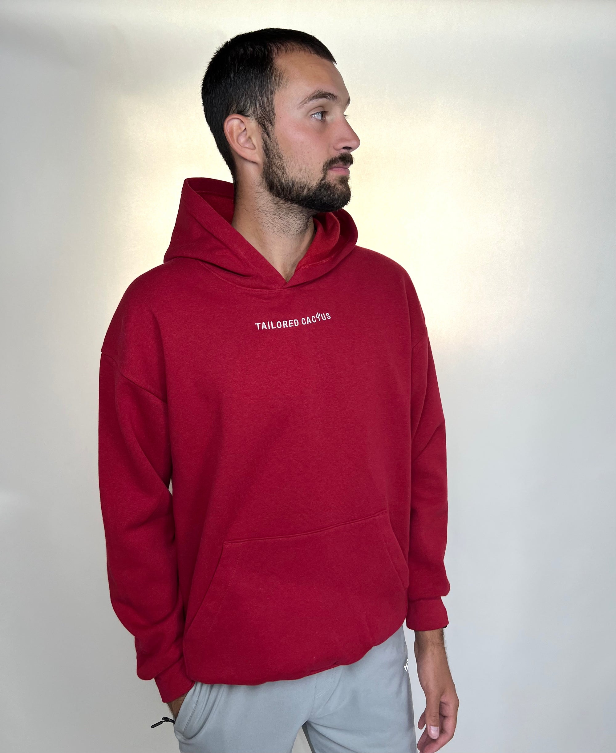 Man in tailored cactus red hoodie 