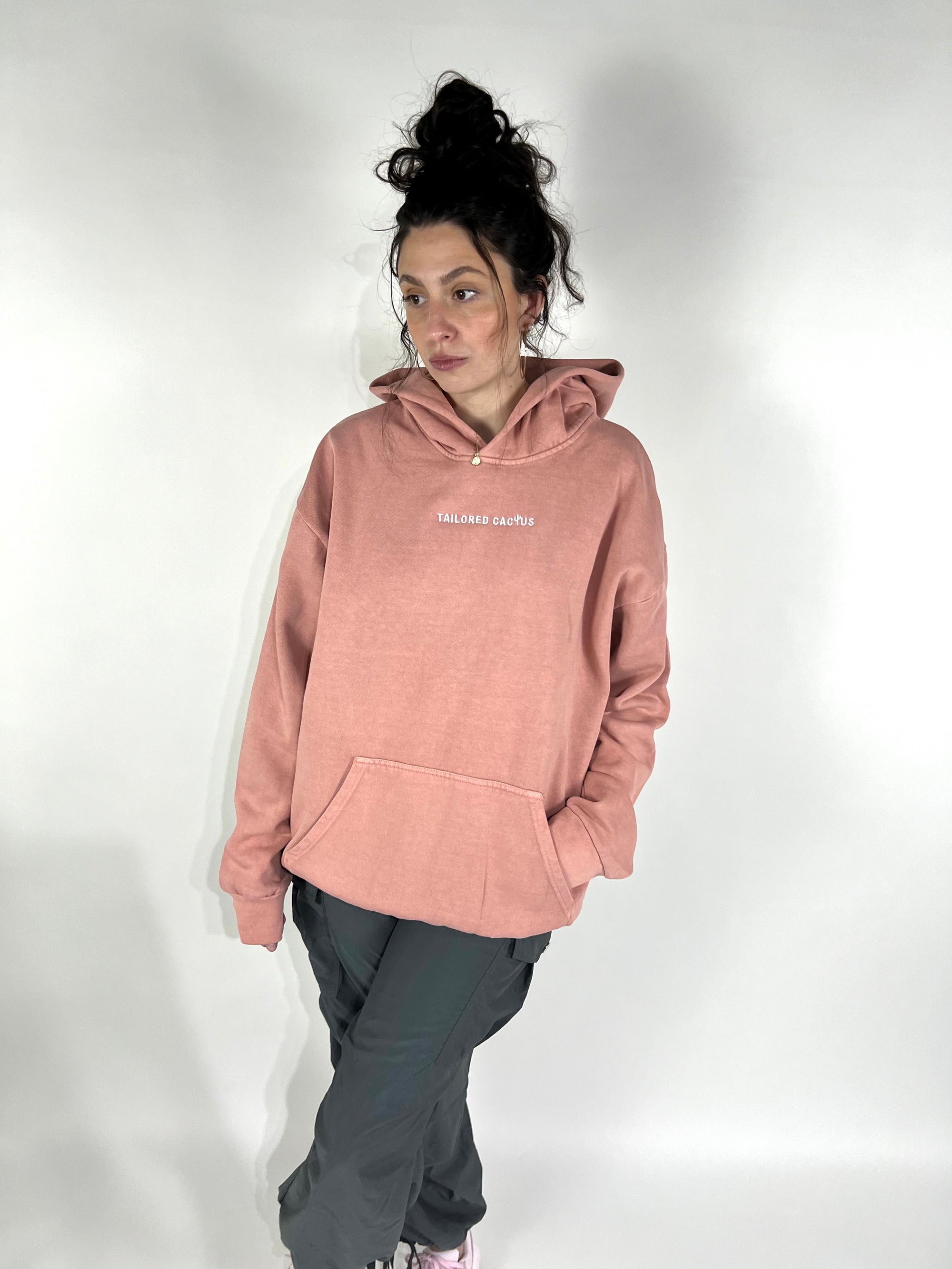 Tailored Cactus girl in pink hoodie with Tailored Cactus on front of hoodie 